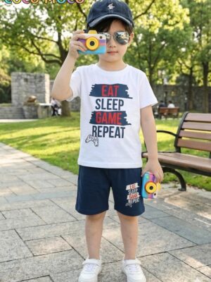 Front view of a boy in TrendWale "Eat Sleep Game Repeat" white t-shirt and matching deep navy shorts.