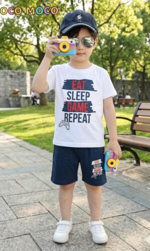 Front view of a boy in TrendWale "Eat Sleep Game Repeat" white t-shirt and matching deep navy shorts.