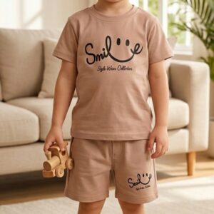 Toddler boy in TrendWale earthy beige two-piece cotton outfit holding a wooden toy.