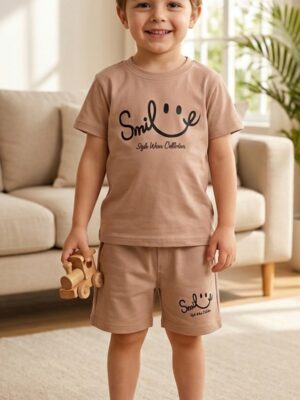 Toddler boy in TrendWale earthy beige two-piece cotton outfit holding a wooden toy.