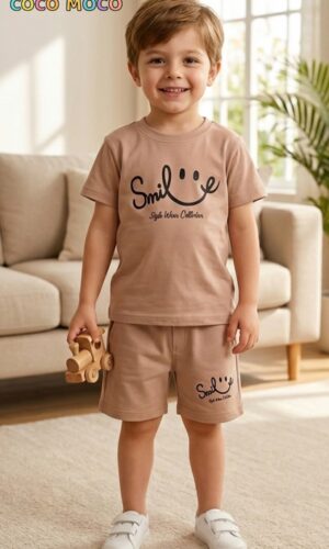 Toddler boy in TrendWale earthy beige two-piece cotton outfit holding a wooden toy.