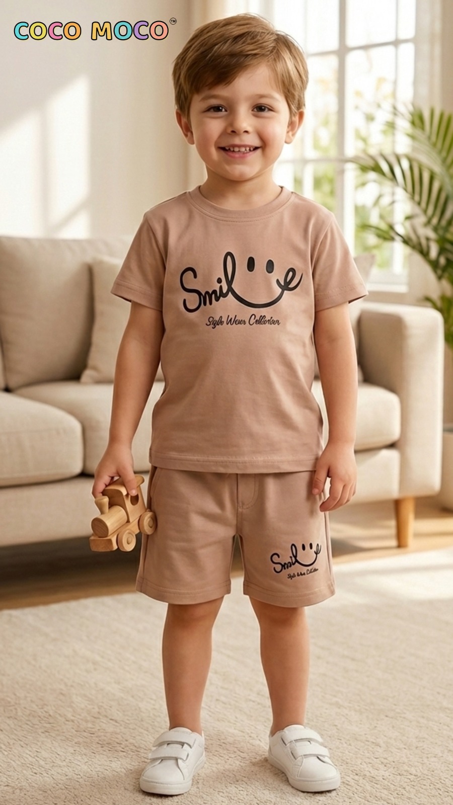Toddler boy in TrendWale earthy beige two-piece cotton outfit holding a wooden toy.